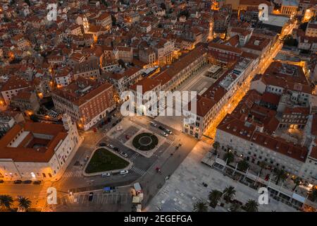 Aerial drone shot of empty republic square by riva with light at dusk in Split old town before sunrise in Croatia Stock Photo