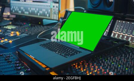 Female Artist, Musician, Producer, Audio Engineer Working in Music Record Studio on a New Album, Use Green Screen Laptop Computer, Control Desk for Stock Photo