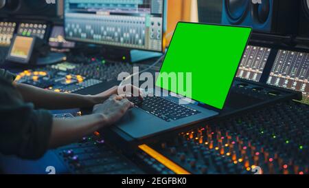 Female Artist, Musician, Producer, Audio Engineer Working in Music Record Studio on a New Album, Use Green Screen Laptop Computer, Control Desk for Stock Photo