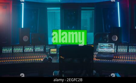 Modern Music Record Studio Control Desk with Green Screen Chroma Key Computer, Equalizer, Mixer and other Professional Equipment. Switchers, Buttons Stock Photo