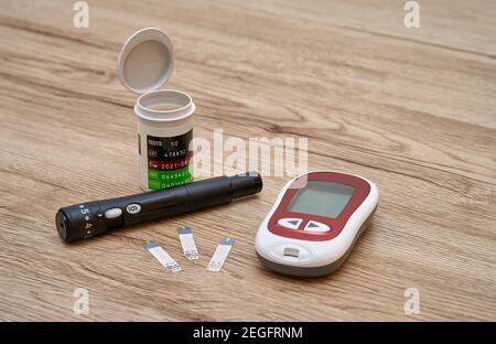 Equipment for measuring blood sugar at home - glucometer test strips and lancet. Stock Photo