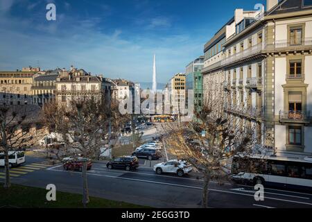 Street view of Geneva with Jet D’eau Water Fountain on background - Geneva, Switzerland Stock Photo