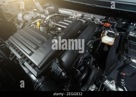 Modern turbocharged eco-friendly engine or motor under vehicle hood close up. Stock Photo