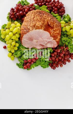 Smoked whole pork ham with fresh fruits. Healthy food. Easter meal. Stock Photo