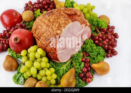 Whole pork ham with fresh fruits. Healthy food. Easter meal. Stock Photo