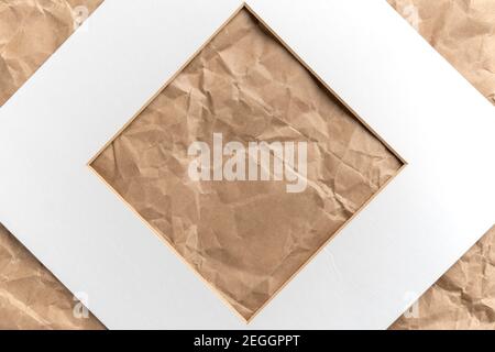 Paper white square cardboard frame on crumpled brown kraft paper. Abstract background. Copy space Stock Photo