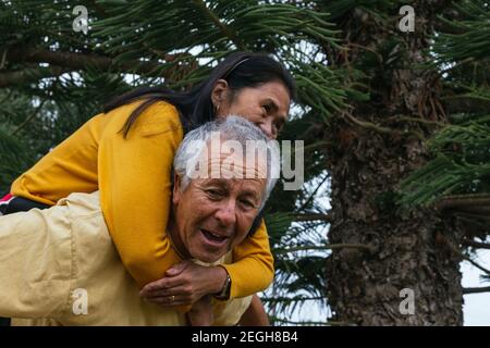 Happy old interracial couple having fun together Stock Photo