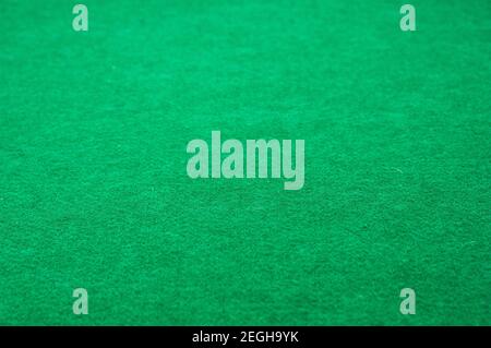Detail of the texture of a green mat used for board games made with synthetic fiber, with copy space Stock Photo