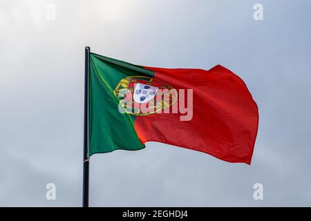 Evolving portuguese flag, clouds on background Stock Photo