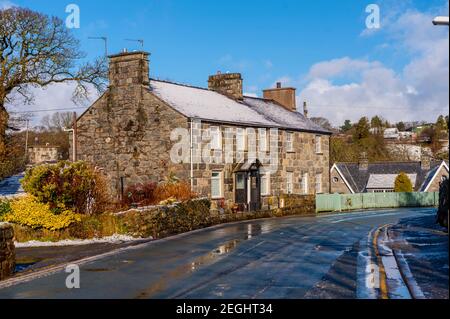 Cottages on the Main Street Llanystumdwy covered with snow on a sunny winters day Stock Photo