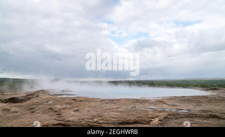 Strokkur geothermal landscape in Iceland with hot water and smoke, Strokkur, Iceland. High concentration of volcanoes is often an advantage in the gen Stock Photo