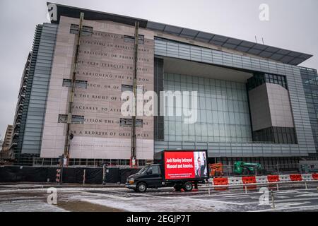 Washington, United States. 18th Feb, 2021. A truck with a sign, 'Josh Hawley Betrayed Missouri and America,' drives by the old Newseum as the First Amendment wall is being removed from the front of the building in Washington, DC Thursday, February 18, 2021. Johns Hopkins University will be taking over the old Newseum building. Photo by Ken Cedeno/UPI Credit: UPI/Alamy Live News Stock Photo