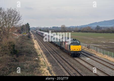 Rail Operations Group class 37 No. 37611 heads south through Northway near Ashchurch with a rake of ex GWR/FGW MK3 HST Coaches from Ely to Newport Stock Photo