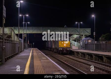 Rail Operations Group class 37 No. 37884 powers up through Ashchurch station with a set of barrier vehicles and tailed with 37611 on the rear having d Stock Photo