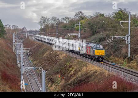 Rail Operations Group Class 37 No. 37884 hauls 321350 and 321351 through Patchway in Bristol en route to Newport Docks scrapyard. Stock Photo