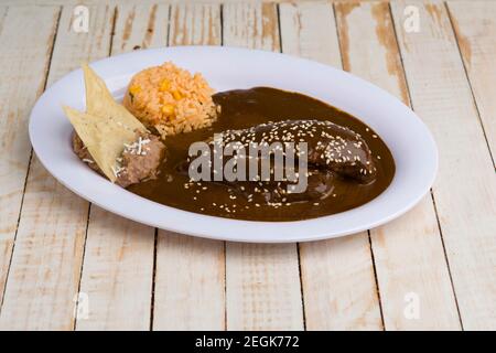 Mexican red mole with chicken, rice and beans Stock Photo