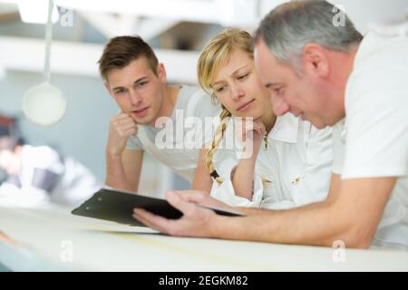 portrait of a painter with apprentices Stock Photo