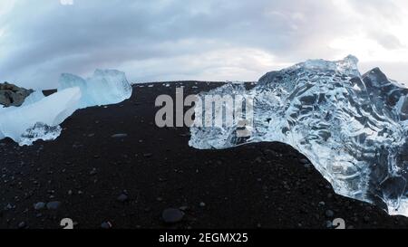 Big different color ice rocks over black sand beach at Diamond beach Iceland Stock Photo