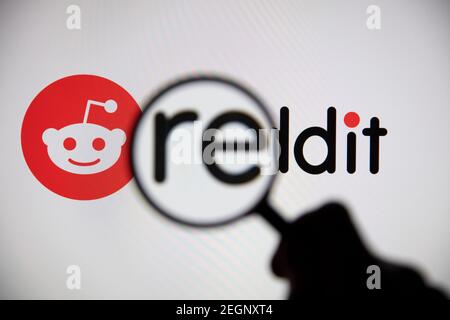 LONDON, UK - February 2021: Reddit logo seen under a magnifying glass Stock Photo