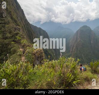 Trail in the mountains that leads to Waynapicchu, mountains in the background and many green vegetation Stock Photo