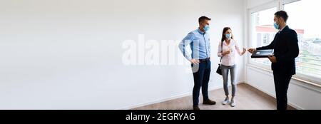 Realtor Showing New Real Estate House In Face Mask Stock Photo