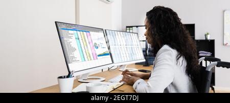 Business Data Analyst Working With Spreadsheet On Computer Stock Photo