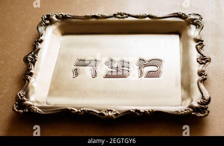 A Silver Tray With The Word Matzah Written On It In Hebrew, Designed For  Matzah, Which Is A Special Bread For Passover Stock Photo - Alamy