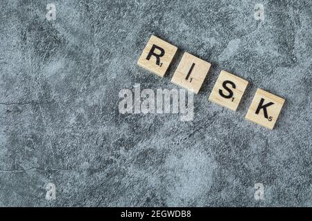 Risk writing with black letters on wooden dices on the marble background Stock Photo