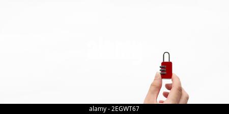 Hand holding red metal lock on white background Concept password. Security Concept. Stock Photo