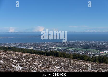 Beautiful aerial-like distant view of Dun Laoghaire harbor, Howth and and ship in the Irish Sea seen from Two Rock Mountain (Fairy Castle), Co. Dublin Stock Photo