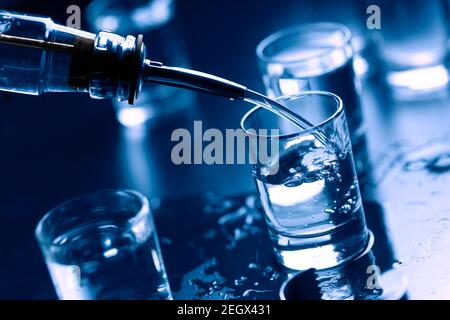 https://l450v.alamy.com/450v/2egx431/russian-vodka-pouring-from-the-bottle-into-glass-in-a-barcopy-space-2egx431.jpg