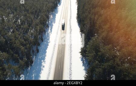 One lorry truck carry cargo on winter road aerial above top drone view Stock Photo