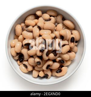 Cooked black-eyed beans in a white ceramic bowl isolated on white. Top view. Stock Photo