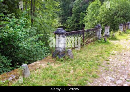 The remains of the railing of the Big white stone bridge in the park of the Serednikovo estate on a summer day Stock Photo