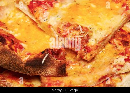 Baked traditional pizza with four kinds of cheese ready to eat. Italian food and restaurants Stock Photo