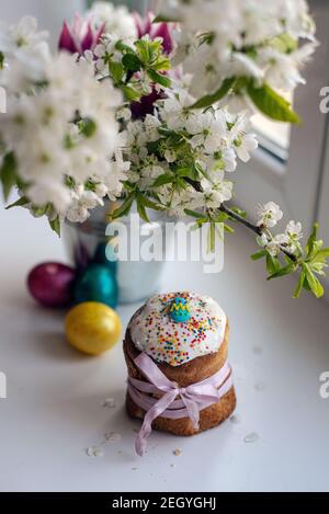 Easter wreath with dyed eggs and spring flowers and blossoming tree branches flatlay Stock Photo