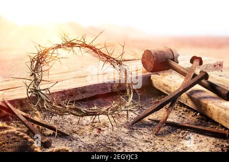 Crucifixion At Sunset - Cross With Crown Of Thorns Hammer And Bloody Nails Stock Photo