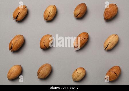 Flat lay with tasty pecan nuts on gray background Stock Photo