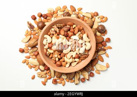 Wooden bowl with different tasty nuts on white background Stock Photo