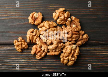 Heap of tasty walnuts on wooden background Stock Photo