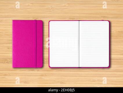 Pink closed and open lined notebooks mockup isolated on wooden background Stock Photo