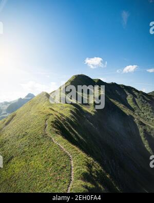 A path alongside a mountain ridge in Vorarlberg, Austria Stock Photo