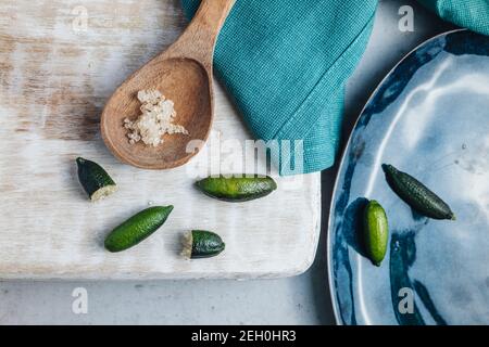 Bunch of fresh tasty finger limes fruits on a table Stock Photo