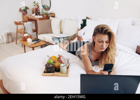 Young woman resting on bed Stock Photo