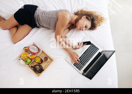 Woman relaxing with smartphone in hands Stock Photo