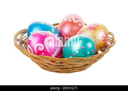 Five easter eggs trendy colored deep blue, green, orange, magenta and golden decorated in basket on white background. Clipping path. Stock Photo