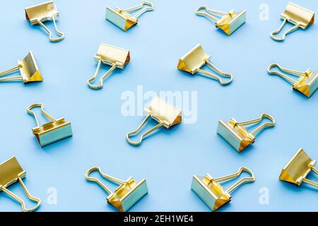 Office supplies pattern. Golden paper binder clips Stock Photo