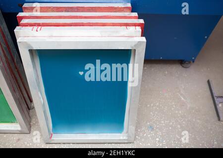 Silk screen printing. Serigraphy. Color paints and fabric. Stock Photo
