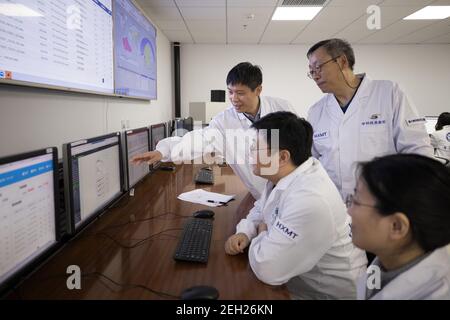 (210219) -- BEIJING, Feb. 19, 2021 (Xinhua) -- Zhang Shuangnan (3rd L), lead scientist of China's Hard X-ray Modulation Telescope (HXMT), works with his colleagues Xiong Shaolin (1st L) and Li Chengkui (2nd L) at the Institute of High Energy Physics under the Chinese Academy of Sciences in Beijing, capital of China, Feb. 18, 2021. China's HXMT, the country's space science satellite also known as Insight, has found that a fast radio burst signal detected last year came from a magnetar in the Milky Way, Chinese scientists announced Friday.   The discovery marked a milestone in understanding the Stock Photo