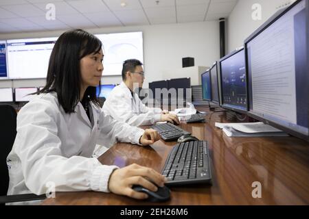 (210219) -- BEIJING, Feb. 19, 2021 (Xinhua) -- Scientists monitor the operation of China's Hard X-ray Modulation Telescope (HXMT) at the Institute of High Energy Physics under the Chinese Academy of Sciences in Beijing, capital of China, Feb. 18, 2021. China's HXMT, the country's space science satellite also known as Insight, has found that a fast radio burst signal detected last year came from a magnetar in the Milky Way, Chinese scientists announced Friday.   The discovery marked a milestone in understanding the nature of the mysterious signal emanating from the universe, the scientists said Stock Photo